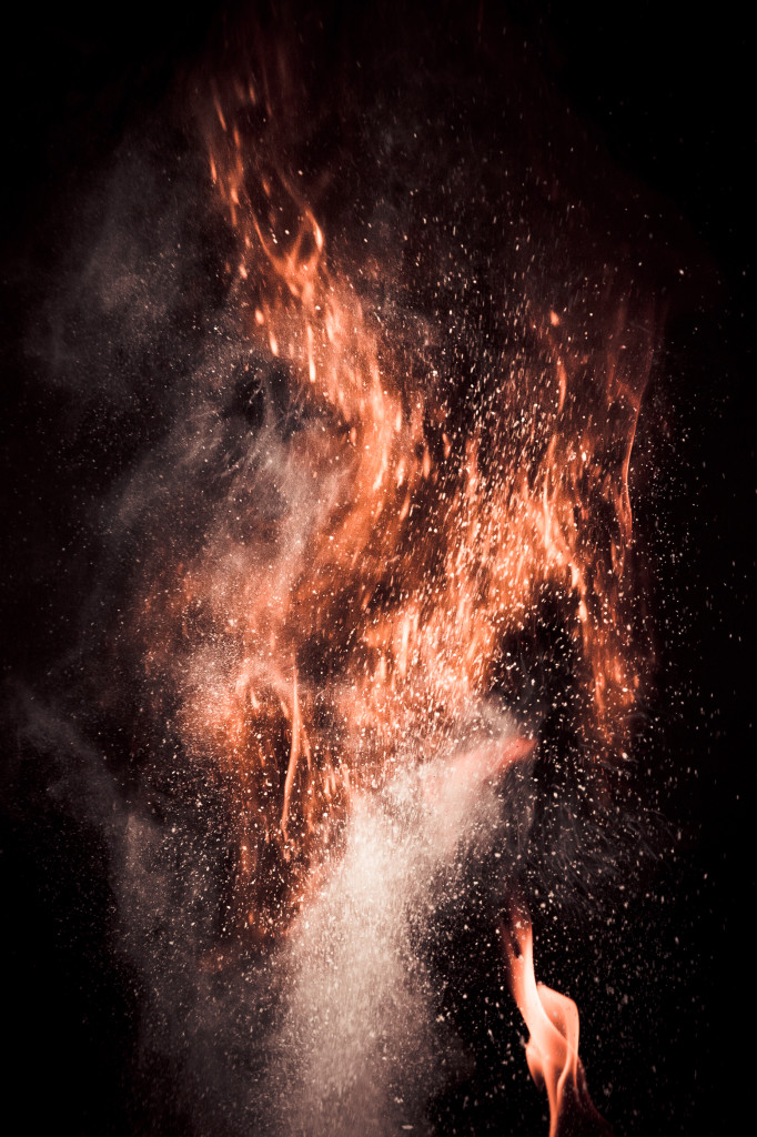 Ignited corn flour against a black backdrop.